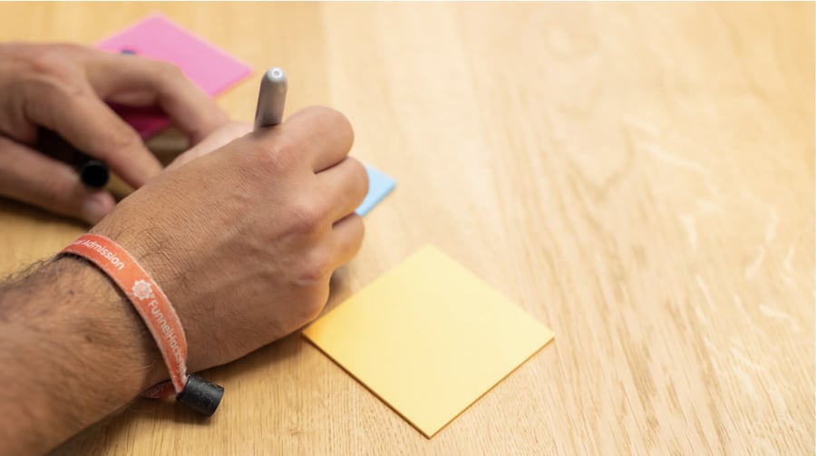 Team member writing on paper